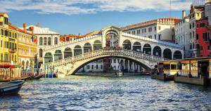 a bridge over a river in a city with buildings at Venice Family & Friends in Mestre