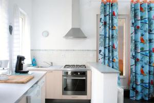 a kitchen with a stove and a sink at Gîte la Providence in Saint-Sernin-du-Plain