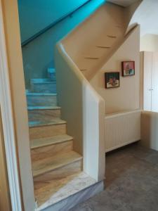 a stairwell in a house with a blue ceiling at Serifos Palace in Livadakia