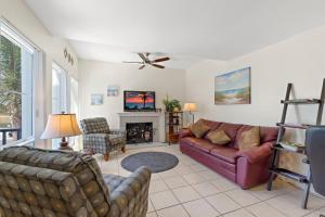 a living room with a couch and a fireplace at Madeira Beach Condo in St. Pete Beach