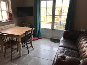 a living room with a wooden table and a couch at Fistral Court in Newquay