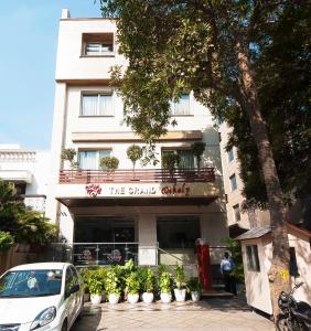 a white car parked in front of a building at The Grand Vikalp By Saga Hotels in New Delhi