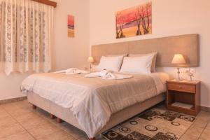 A bed or beds in a room at Roula Apartments