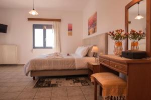 A bed or beds in a room at Roula Apartments