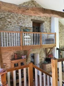 a room with a staircase and a stone wall at No 6 in Dournazac