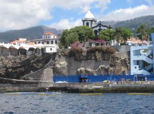 a large body of water with a boat on top of it at Vitorina Corte Guesthouse in Funchal