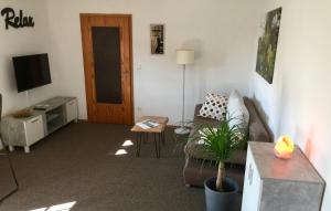 a living room with a couch and a tv at Ferienwohnung Maintal Würzburg in Würzburg