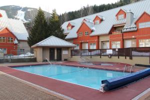 a large swimming pool in front of a building at Lake Placid Lodge by Whistler Retreats in Whistler