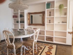 - une salle à manger avec une table, des chaises et un miroir dans l'établissement Apartamento centro frente a Torres de Serrano, à Valence