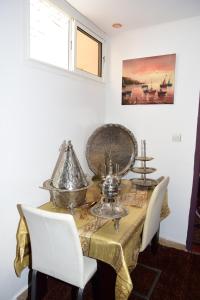 a dining room with a table with silverware on it at Dar Amine in Rabat