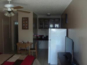 a kitchen with a white refrigerator and a table at Newly Furnished Large, Clean, Quiet Private Unit in Fort Lauderdale