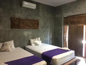Ein Bett oder Betten in einem Zimmer der Unterkunft Watukarung Ristu Homestay