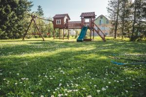 a playground with a slide in the grass at Villa Żywiec in Żywiec