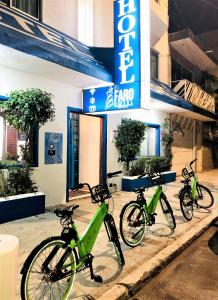 three bikes parked in front of a store at Hotel El Faro Malecon in Veracruz