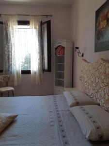 a bedroom with a large bed and a window at Il Focolare B&B in Casa Ottani