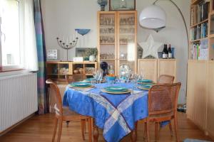 a dining room table with chairs and a blue table cloth at La Mésange bleue in Saint-Barthélemy