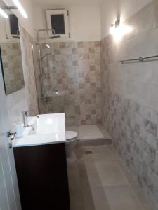 a bathroom with a sink and a toilet and a shower at Villa Ligia Beach in Koundouros +24 photos