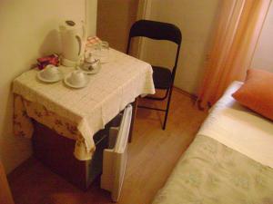 a small table in a room with a bed and a chair at Room Center Old Town in Dubrovnik