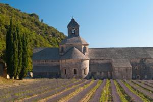 an old church with a clock tower in a field at Bastidon Provencal in Gordes