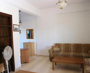 a living room with a couch and a table at Oliaria Apartments in Plataniás