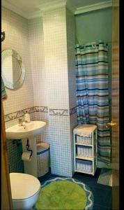 a bathroom with a sink and a toilet and a shower at El Rincón de las Marismas in Carasa