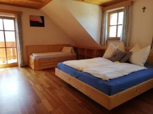 a bedroom with a bed and a bench in a attic at Paulbauer in St. Wolfgang
