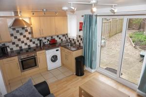 a kitchen with a washer and dryer in a room at Grange Apartment in Bristol