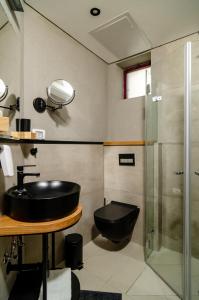 a bathroom with a black sink and a shower at Biazi Hotel in Jerusalem