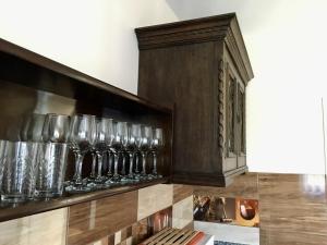 a shelf with wine glasses on a wall at Mátrai Vadászház in Mátraterenye