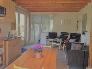 a kitchen and living room with a table and chairs at Het Duintje in Castricum