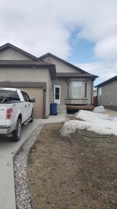 a white truck parked in front of a house at Home in Winnipeg