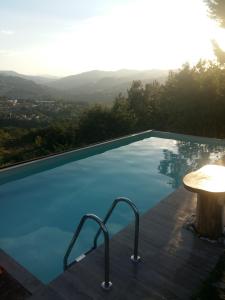 a swimming pool with a view of the mountains at Nido D'Ape bed and breakfast in  Montepetra 