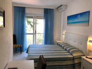 Postel nebo postele na pokoji v ubytování Hotel Bahamas