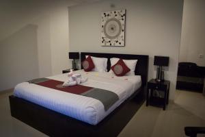 a bedroom with a bed with a stuffed animal on it at Kelapa Lovina Beach Villa in Lovina