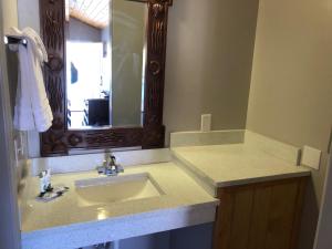 uma casa de banho com um lavatório e um espelho em Red Canyon Cabins em Kanab