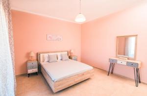 a bedroom with a bed and a window at Xristiana's House by CorfuEscapes in Kastanéa
