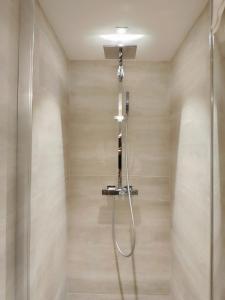 a shower with a shower head in a bathroom at Le Chalet des Boisses, Luxury Ski-In Ski-Out Chalet for 12 in Tignes +41 photos