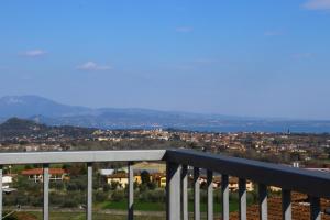 a view of a city from a balcony at "Country House il Brolo" in Polpenazze del Garda