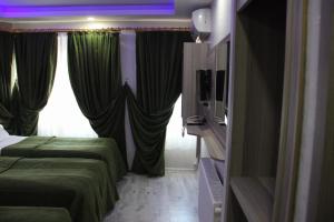 a hotel room with two beds and a window at Kaya Madrid Hotel in Istanbul