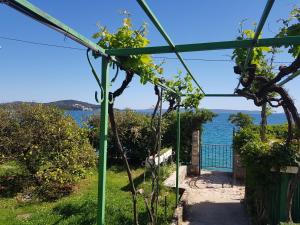 a greenhouse with a view of the water at Holiday Home Margarita in Seget Vranjica