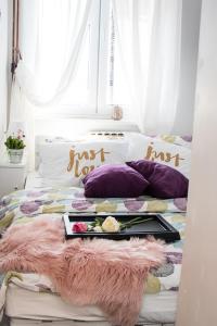 a bed with a tray of food on it at Apartment Travel hub *** in Varaždin