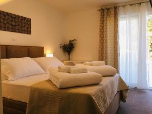 a bedroom with two beds with white sheets and a window at HOLIDAY HVAR lux in Basina +46 photos