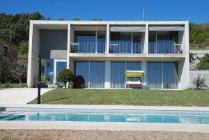 a house with a swimming pool in front of it at Quinta Pedras De Baixo in Longos