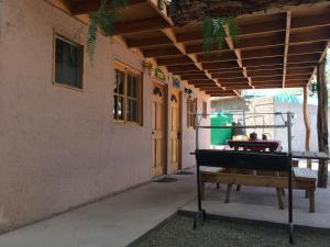 a piano sitting outside of a building with a table at Refugio Don Natu in San Pedro de Atacama