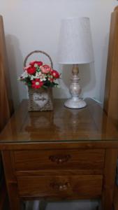a table with a lamp and a basket of flowers at 宜蘭樸實園民宿 in Jiaoxi
