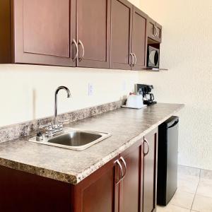 a kitchen with a sink and a counter top at Prairie Moon Inn & Suites Unity in Unity