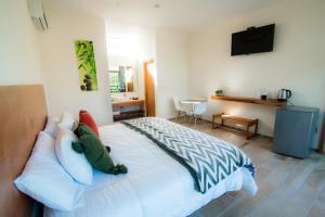 - une chambre avec un grand lit blanc et une télévision dans l'établissement Siete Cielos, à La Laguna