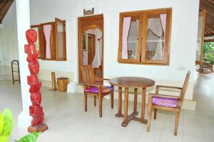 a dining room with a table and chairs in a room at Felicianas Resort in Tejakula