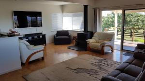 a living room with chairs and a wood stove at 505 CONROD STRAIGHT MOUNT PANORAMA in Bathurst