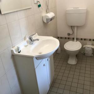 a bathroom with a sink and a toilet at Travelway Motel in Port Pirie